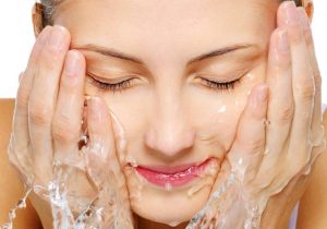 Image of A Young Woman Washes Her Face With Pure Water To Take Care of Her Skin.